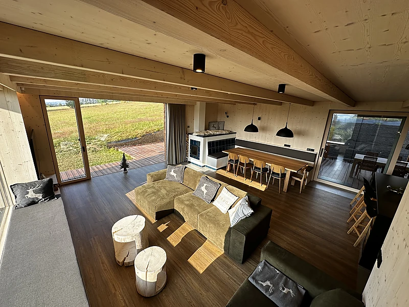 Living room with the dining table and a view of the meadow