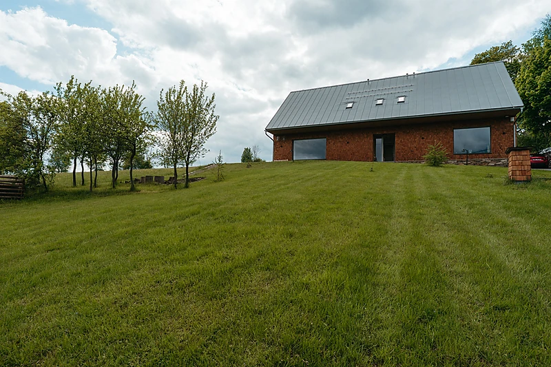 The chalet on its mown meadow with the garden