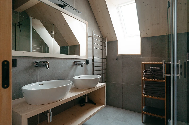 Bathroom with two basins under a roof window