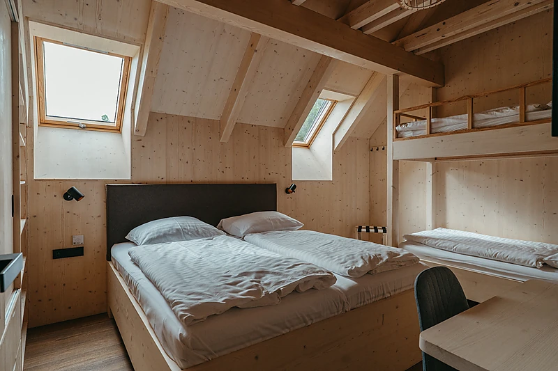 Bedroom with a bunk bed under the roof windows