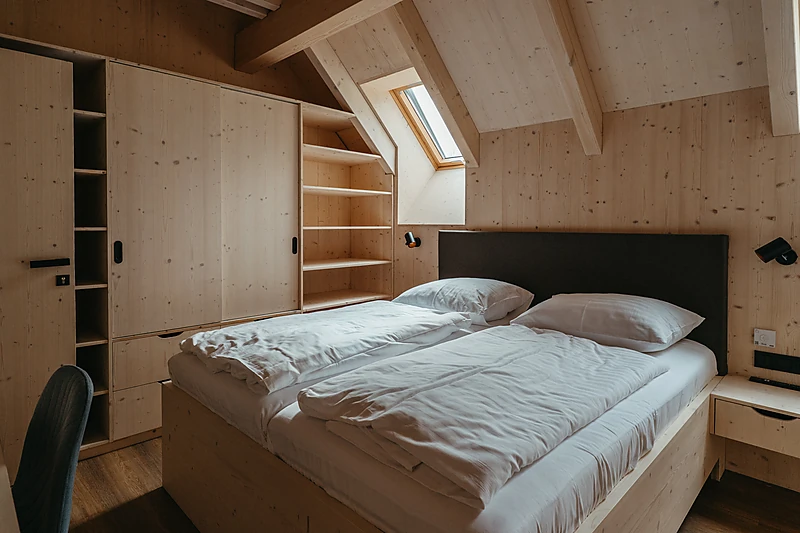Bedroom with built-in wardrobes under the rafters