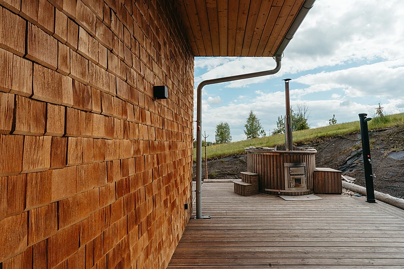 Hot tub on the terrace beside the shingled wall