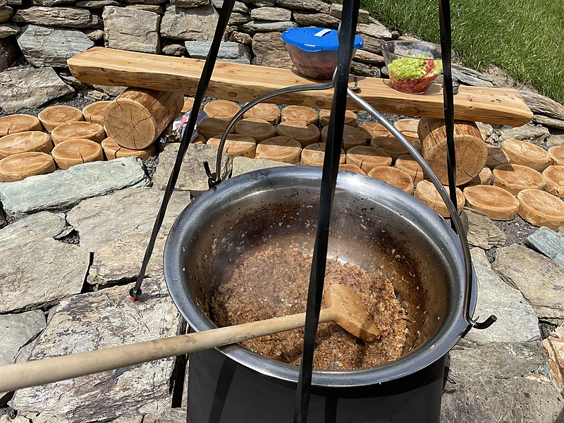 A cooking pot over the fire pit