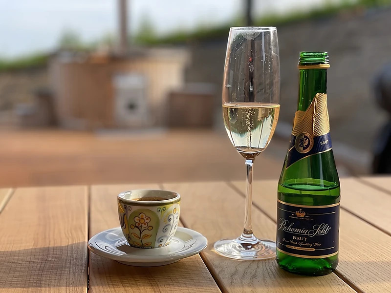 A glass of wine and coffee on the terrace table