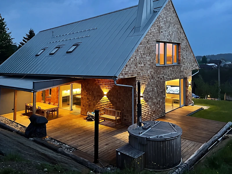 Covered terrace with the hot tub at dusk