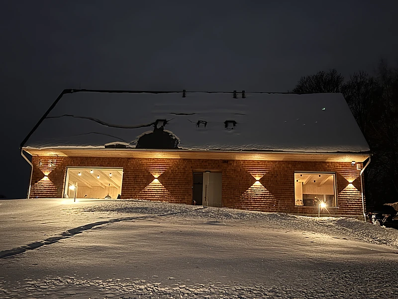 The snowed-in chalet from the front at night
